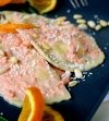 Ravioli à la ricotta en sauce au saumon, orange et pignons